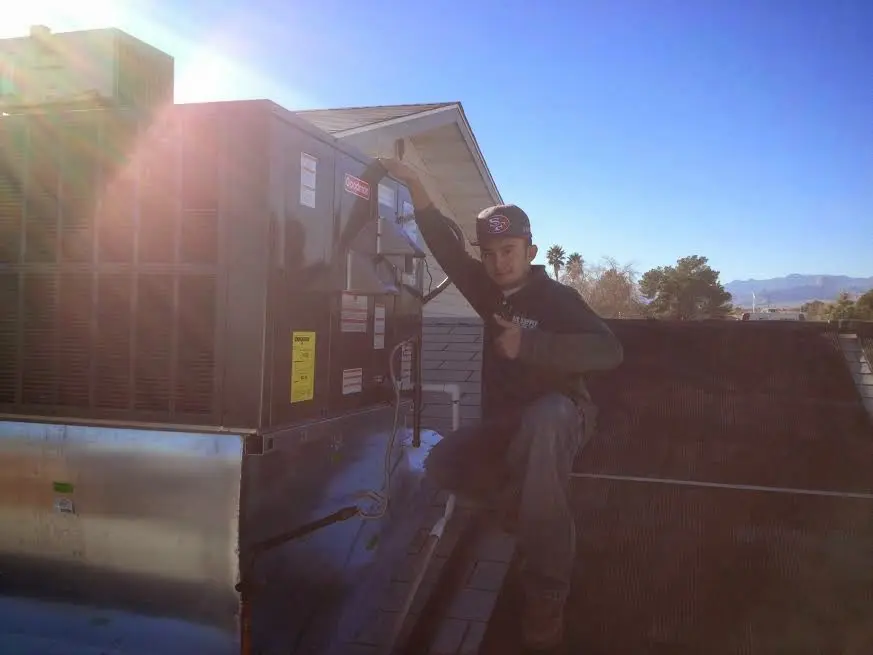 HVAC technician performing Boiler Repair on a rooftop unit in Cleveland